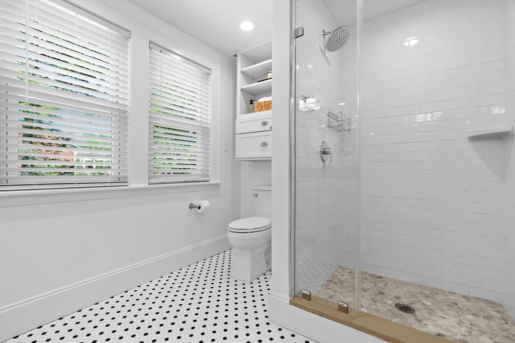 16 Vine Brook Road Lexington, MA 02421 - Photo 23 of 37 a bathroom with a granite countertop sink a toilet and a shower