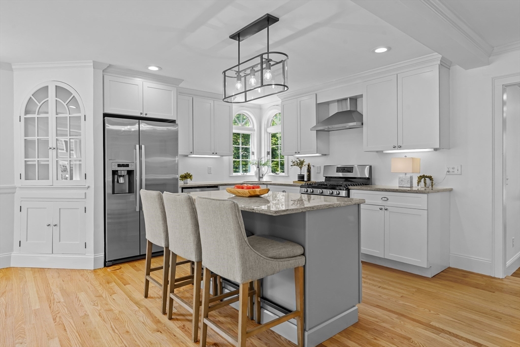 16 Vine Brook Road Lexington, MA 02421 - Photo 4 of 37 a kitchen with stainless steel appliances granite countertop a refrigerator a sink dishwasher a stove and white cabinets with wooden floor