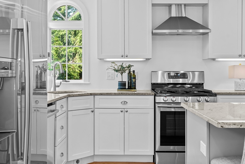 16 Vine Brook Road Lexington, MA 02421 - Photo 8 of 37 a kitchen with white cabinets and a stove