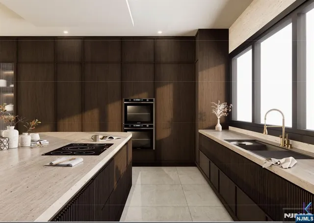 a kitchen with a sink and a stove top oven