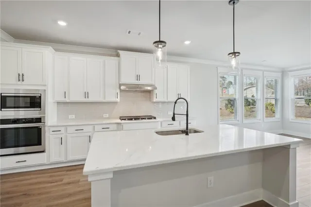 a view of a bedroom with wooden floor and bathroom
