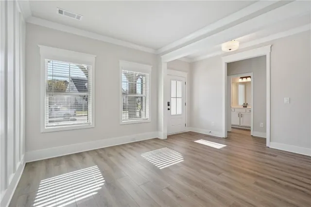an empty room with a window and a ceiling fan