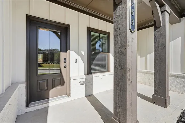 an empty room with wooden floor a fireplace and windows