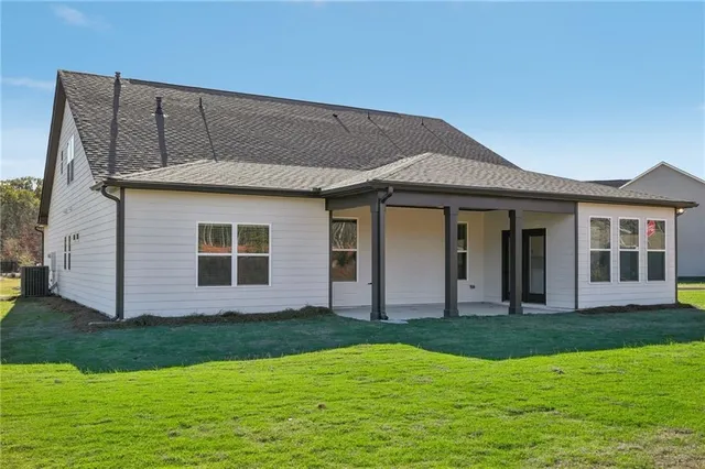 a view of a house with backyard and swimming pool