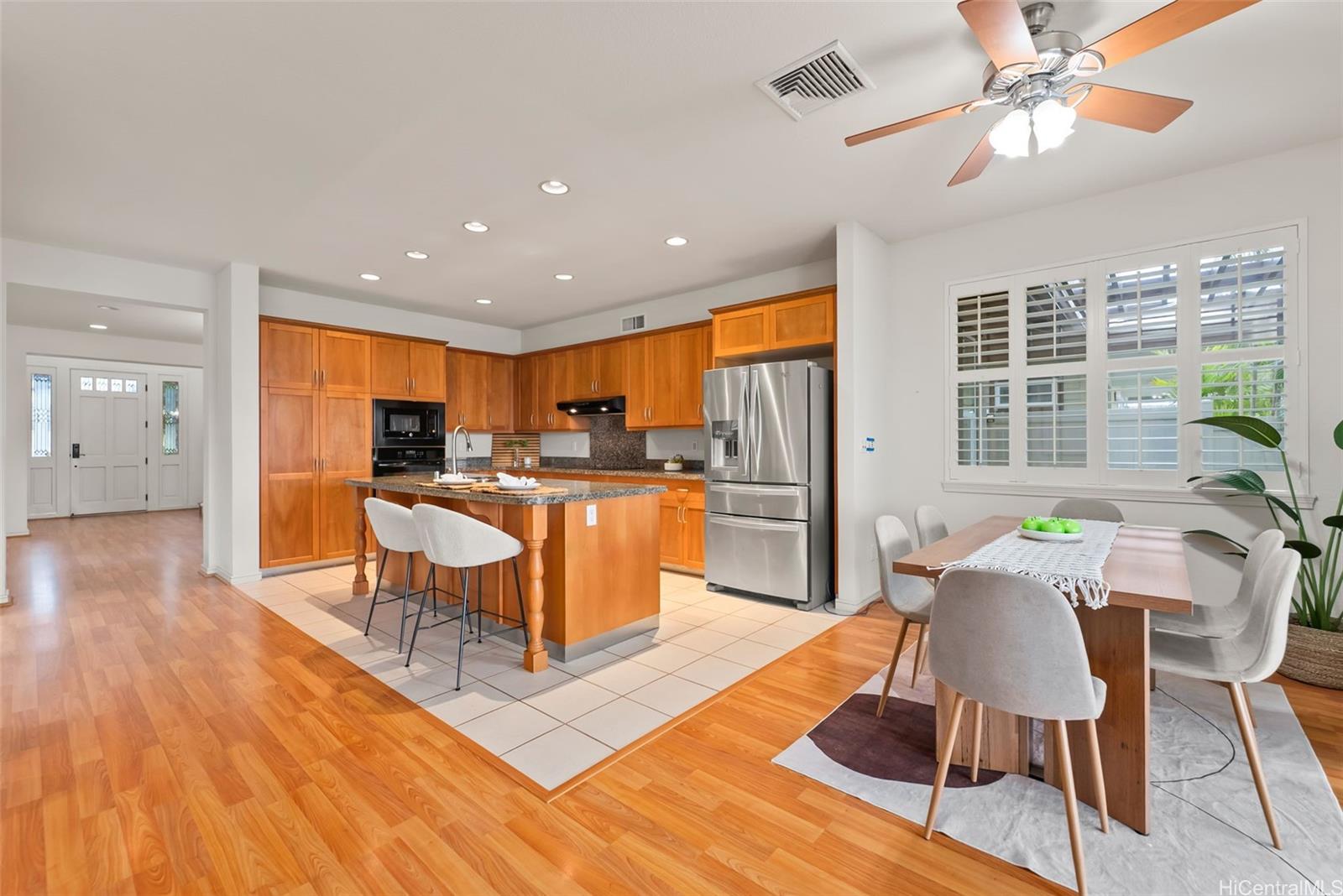 520 Lunalilo Home Road, Unit ER126 Honolulu, HI 96825 - Photo 12 of 25 a living room with stainless steel appliances kitchen island granite countertop wooden floor a dining table and chairs