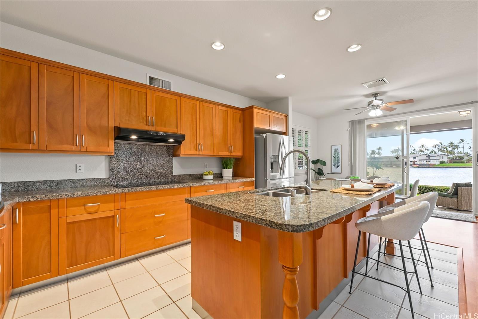 520 Lunalilo Home Road, Unit ER126 Honolulu, HI 96825 - Photo 13 of 25 a kitchen with stainless steel appliances granite countertop a sink a stove a table and chairs