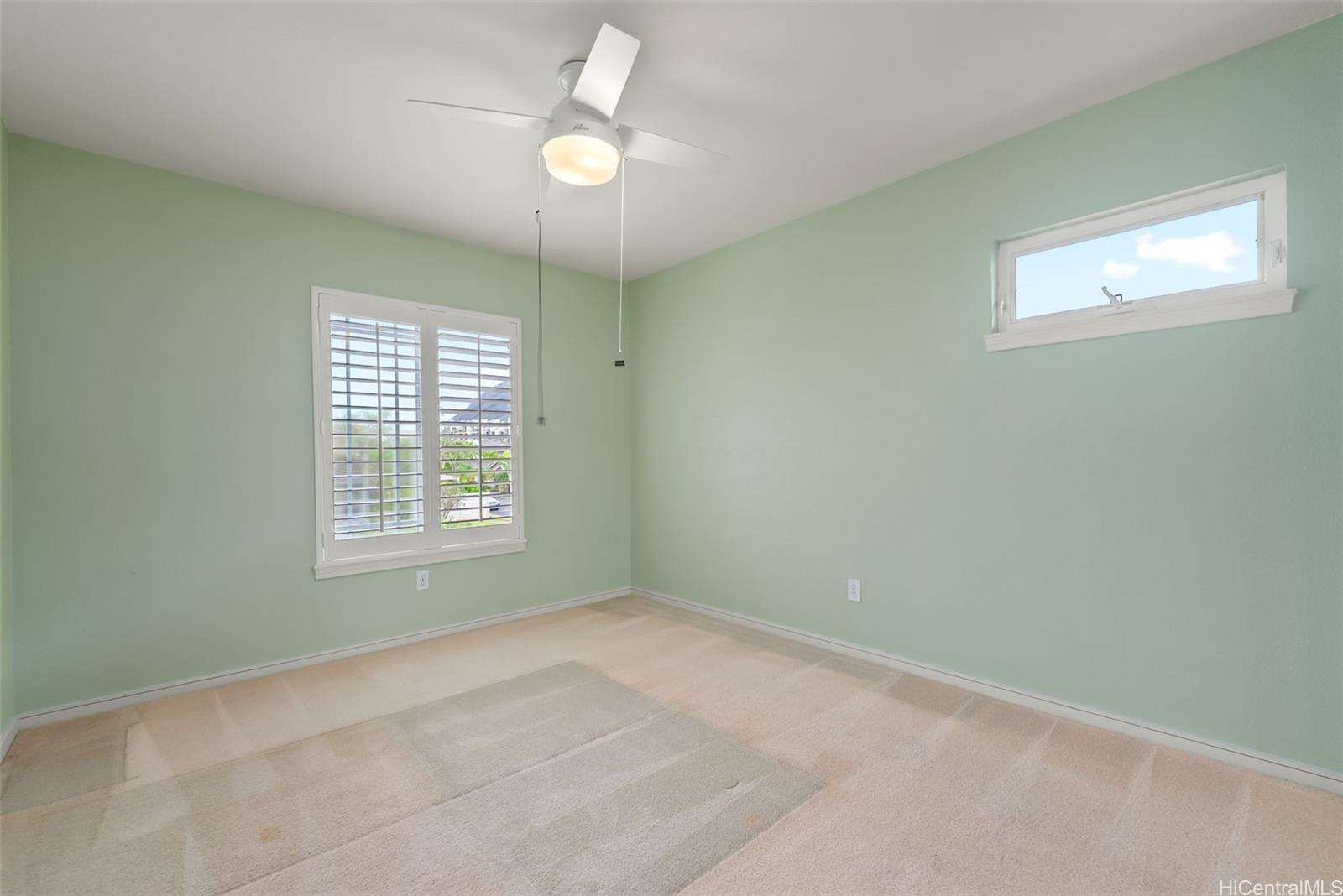 520 Lunalilo Home Road, Unit ER126 Honolulu, HI 96825 - Photo 19 of 25 an empty room with windows and fan