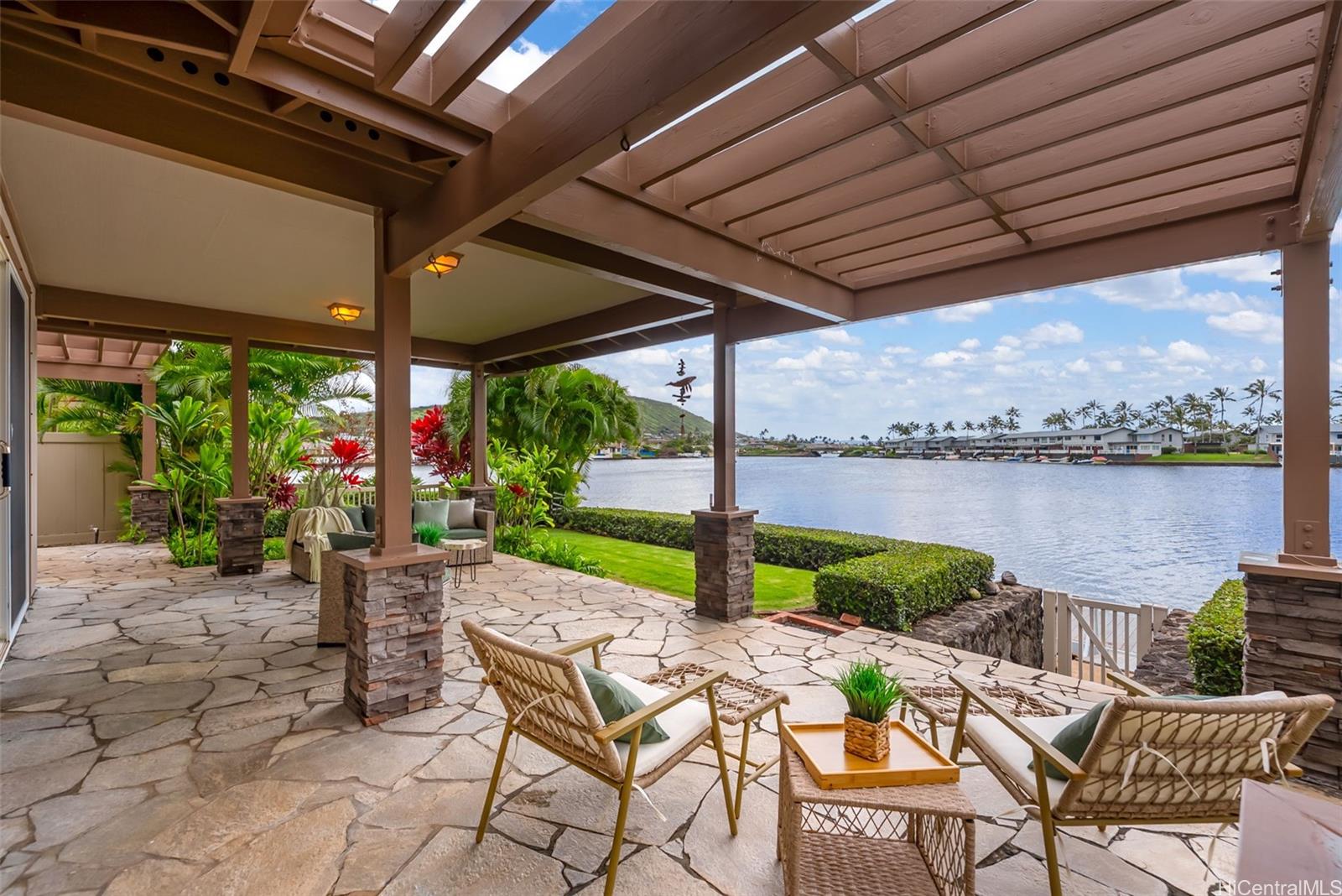 520 Lunalilo Home Road, Unit ER126 Honolulu, HI 96825 - Photo 2 of 25 a view of a patio with a table chairs and a swimming pool