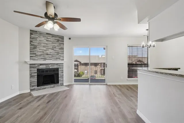 a view of a kitchen with wooden floor and a fireplace