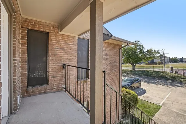 a view of a porch with a floor to ceiling window and a yard