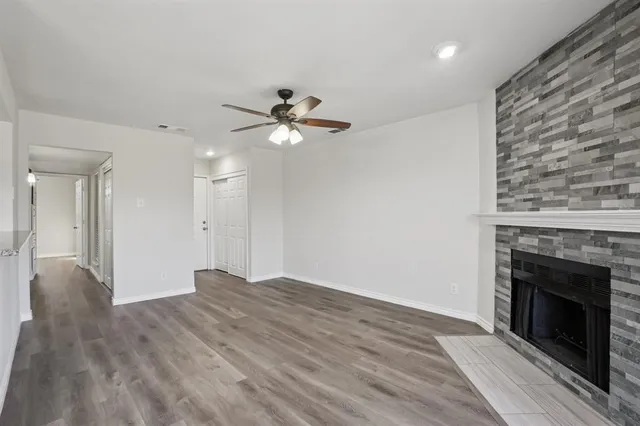 wooden floor in an empty room with a fireplace