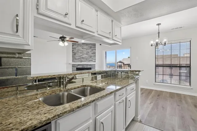 a kitchen with a sink cabinets and window