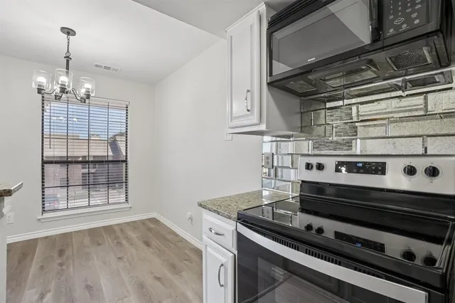 a stove top oven sitting inside of a kitchen