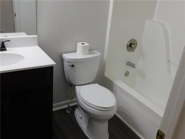 a white toilet sitting next to a bathroom sink