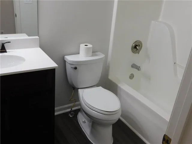a white toilet sitting next to a bathroom sink