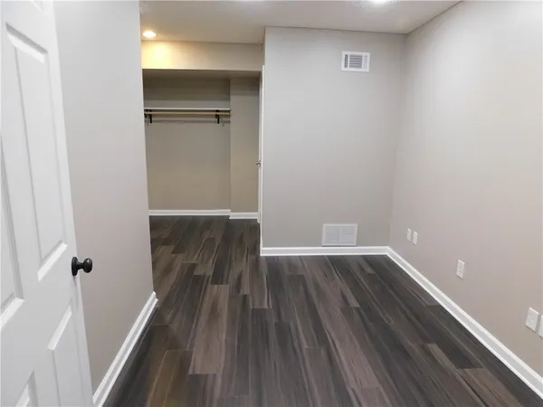 a view of a room with wooden floor and staircase