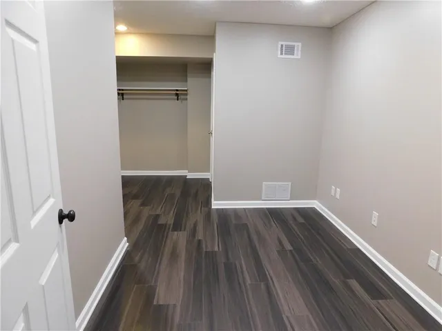 a view of a room with wooden floor and staircase