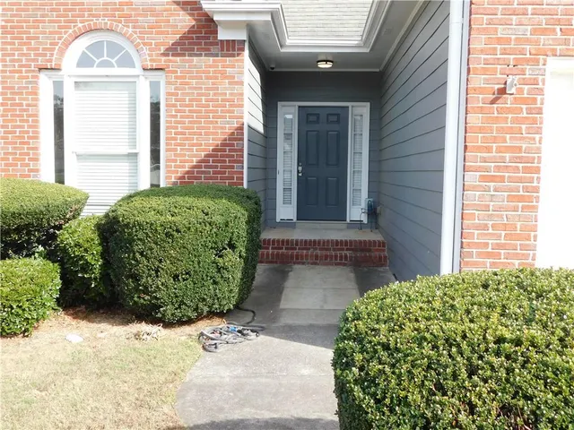 a front view of a house with garden