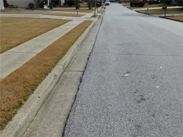 a view of a swimming pool with a yard