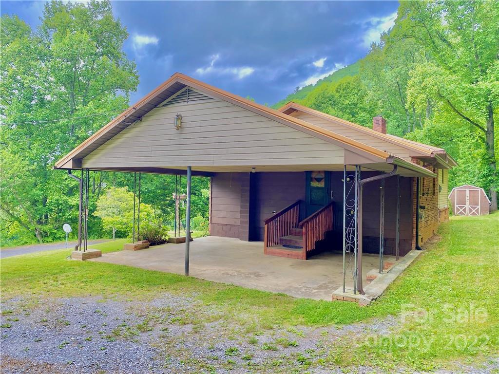 107 Old Mine Road Canton, NC 28716 - Photo 4 of 17 a view of a house with a yard potted plants and a large tree