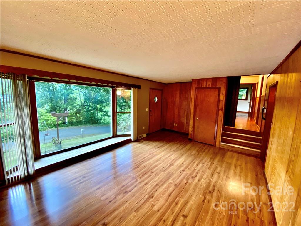 107 Old Mine Road Canton, NC 28716 - Photo 8 of 17 a view of empty room with wooden floor and fan
