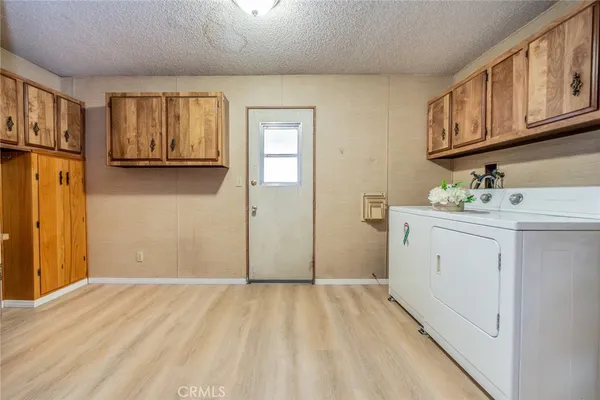 a view of a kitchen with stainless steel appliances granite countertop a sink and cabinets