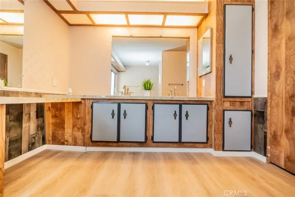 a bathroom with a tub sink and mirror