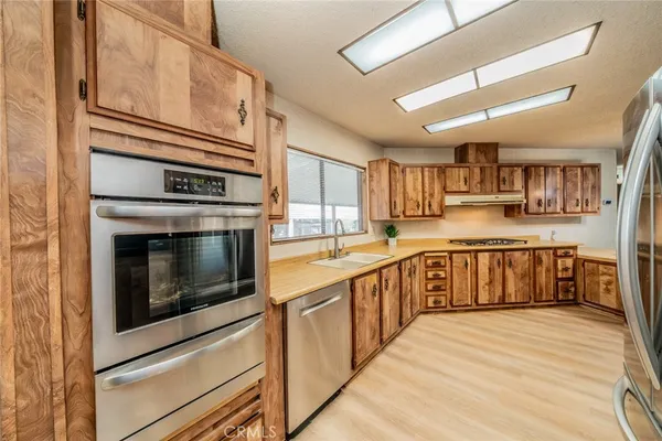 a kitchen with stainless steel appliances granite countertop a stove and a sink