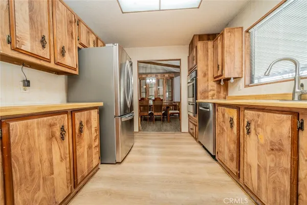 a view of a hallway with furniture and a window