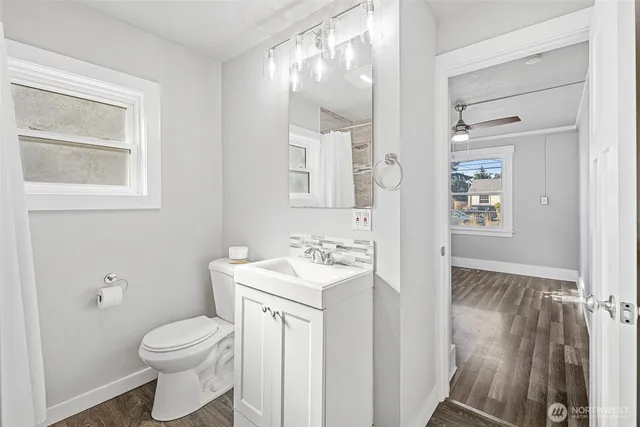 a bathroom with a sink a toilet and shower