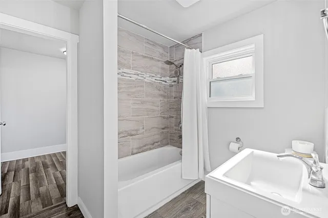a bath room with a sink and a bath tub