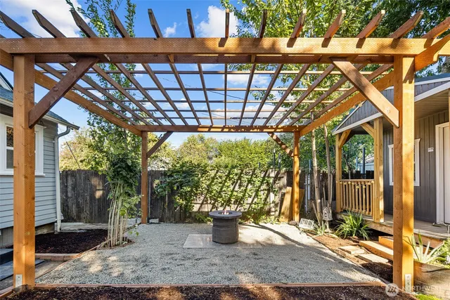 a backyard of a house with barbeque oven table and chairs