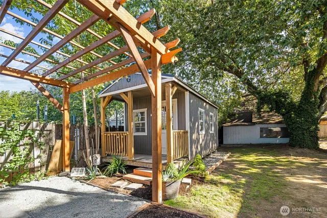 a front view of a house with a tree
