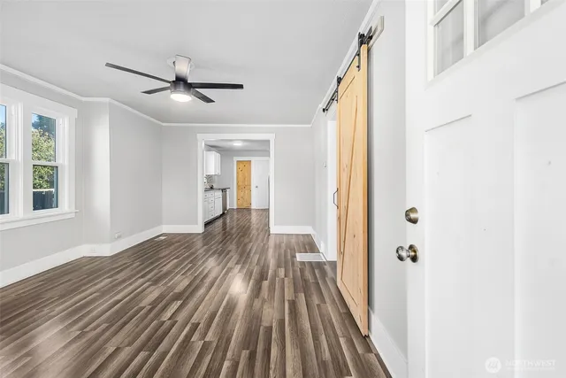 a view of a hallway with wooden floor and staircase