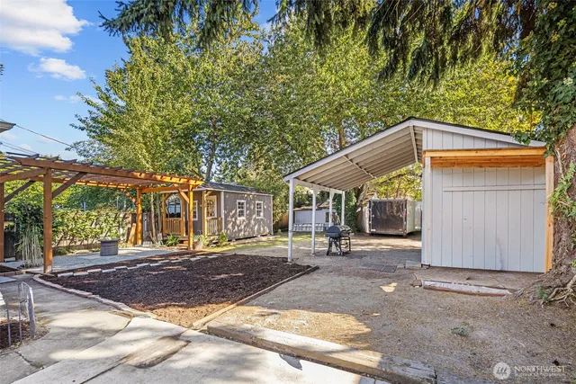 a patio with a table and chairs under an umbrella