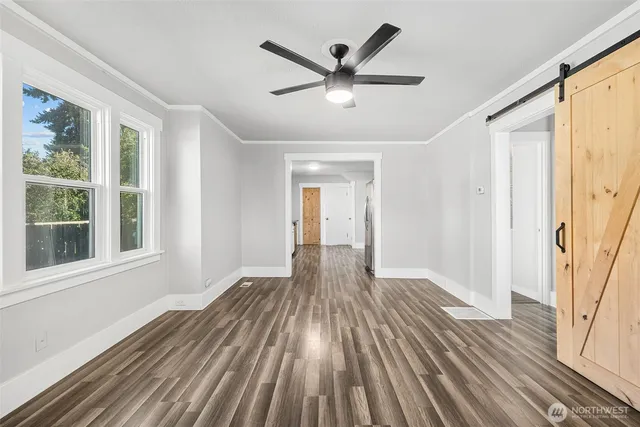 wooden floor in an empty room with a window