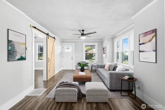 a living room with furniture and wooden floor