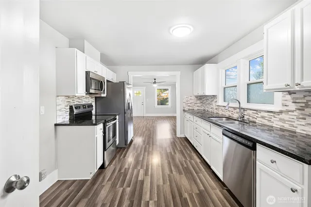a kitchen with kitchen island granite countertop lots of counter top space and stainless steel appliances