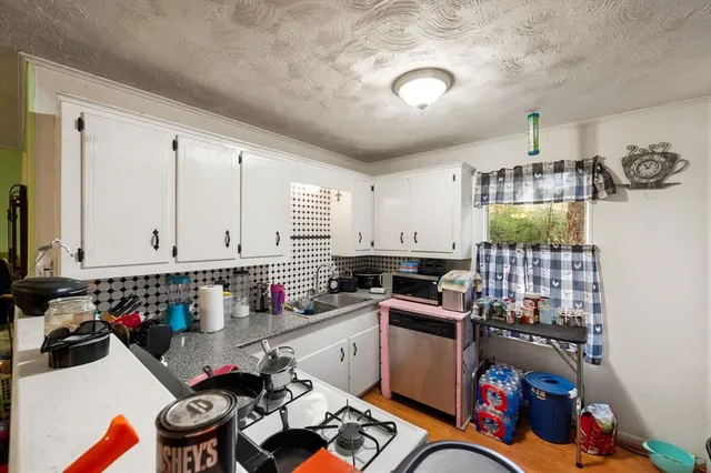 a kitchen with lots of counter top space and a window