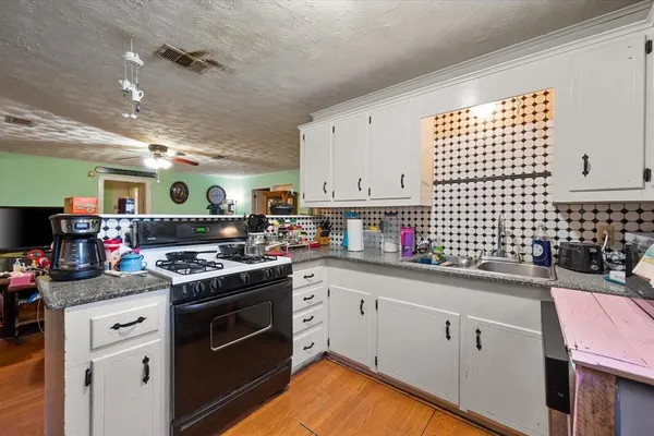 a kitchen with a sink cabinets and window