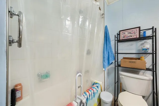 a white toilet sitting next to a bathroom sink