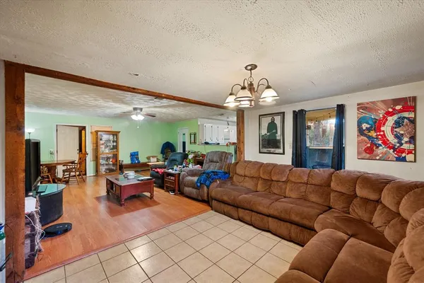 a living room with furniture or couch and a chandelier