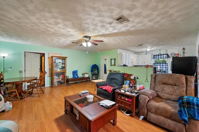 a living room with furniture and kitchen view