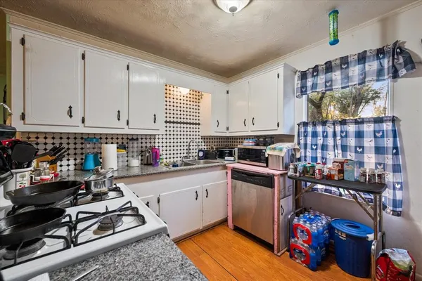 a kitchen with stainless steel appliances granite countertop a stove and a sink