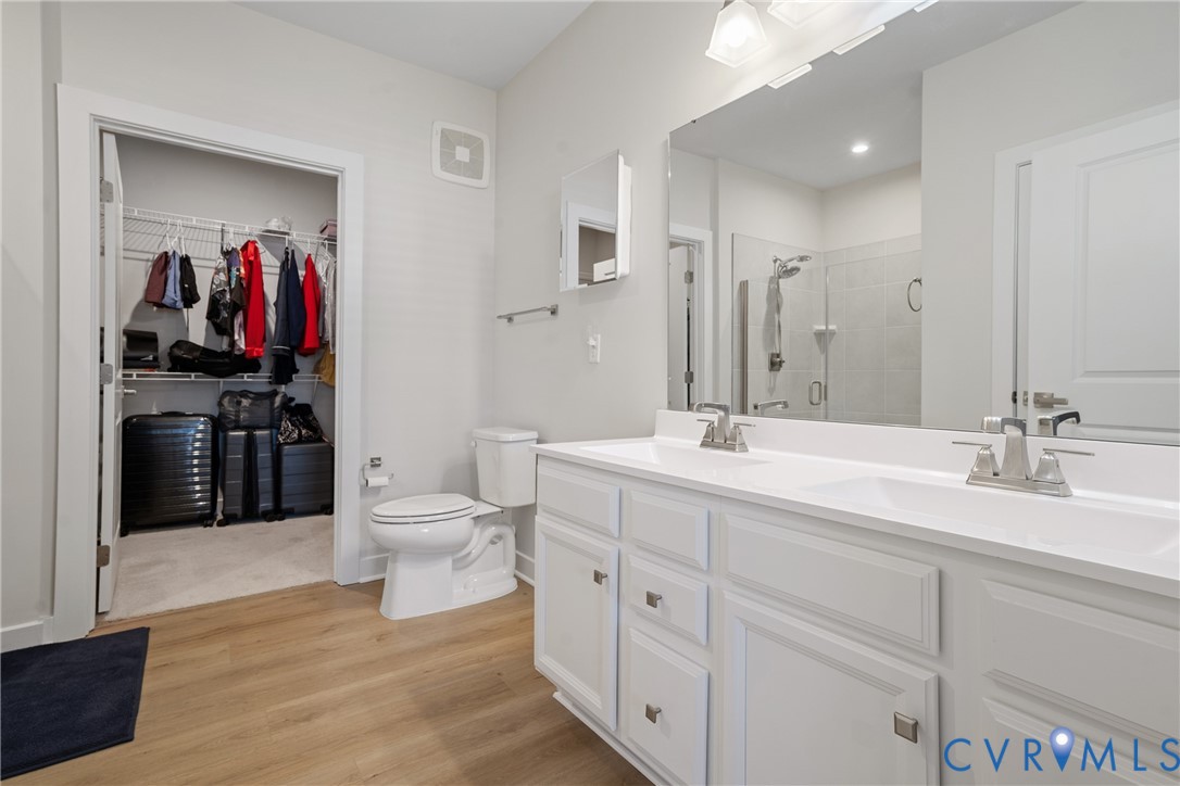 6601 Citory Way, Unit 304 Moseley, VA 23120 - Photo 11 of 33 a spacious bathroom with a double vanity sink and a mirror