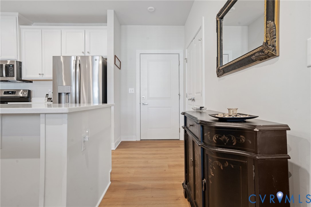 6601 Citory Way, Unit 304 Moseley, VA 23120 - Photo 17 of 33 a kitchen with stainless steel appliances granite countertop a refrigerator and a stove