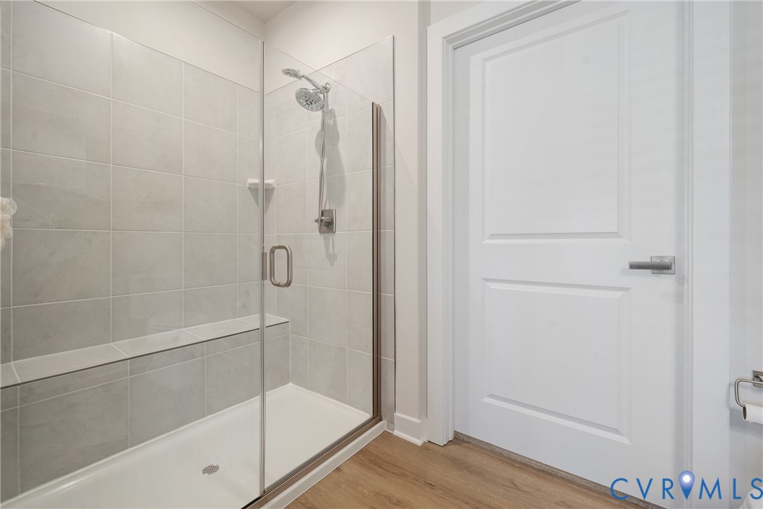 6601 Citory Way, Unit 304 Moseley, VA 23120 - Photo 18 of 33 a bathroom with a glass shower door