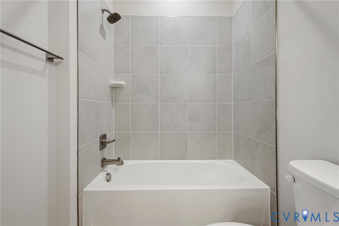 6601 Citory Way, Unit 304 Moseley, VA 23120 - Photo 19 of 33 a white bath tub and a shower