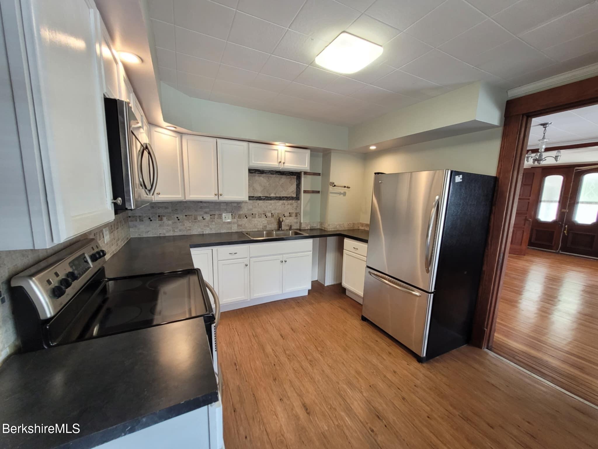 14 Pine Street Adams, MA 01220 - Photo 2 of 8 a kitchen with granite countertop a refrigerator and a sink