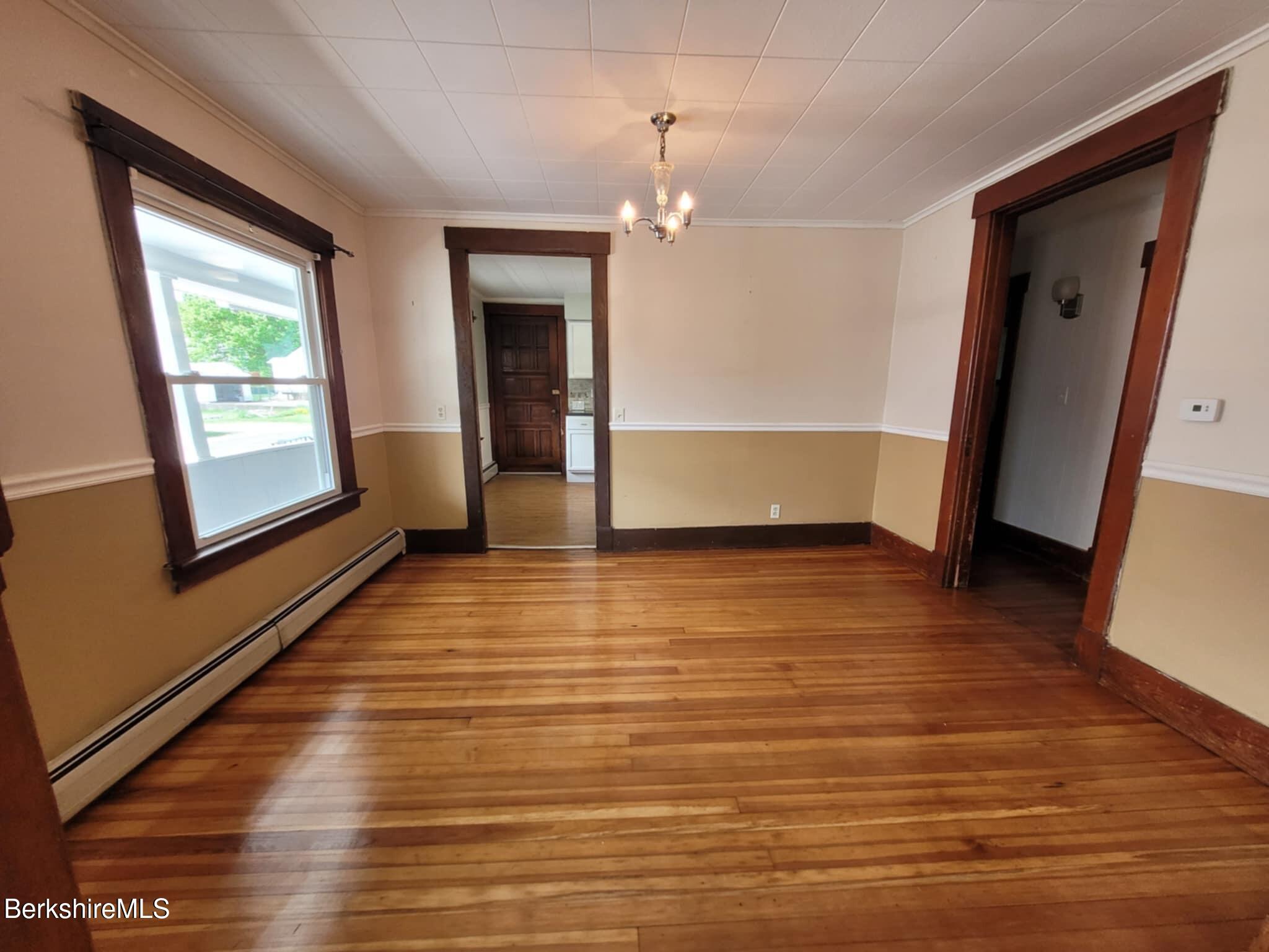 14 Pine Street Adams, MA 01220 - Photo 3 of 8 a view of empty room with wooden floor and fan